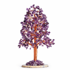 Amethyst crystal tree with lavender purple leaves on copper wire branches on wooden surface
