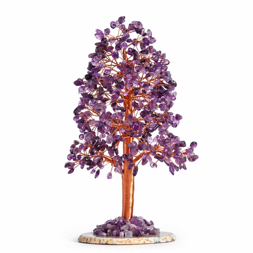 Amethyst crystal tree with lavender purple leaves on copper wire branches on wooden surface