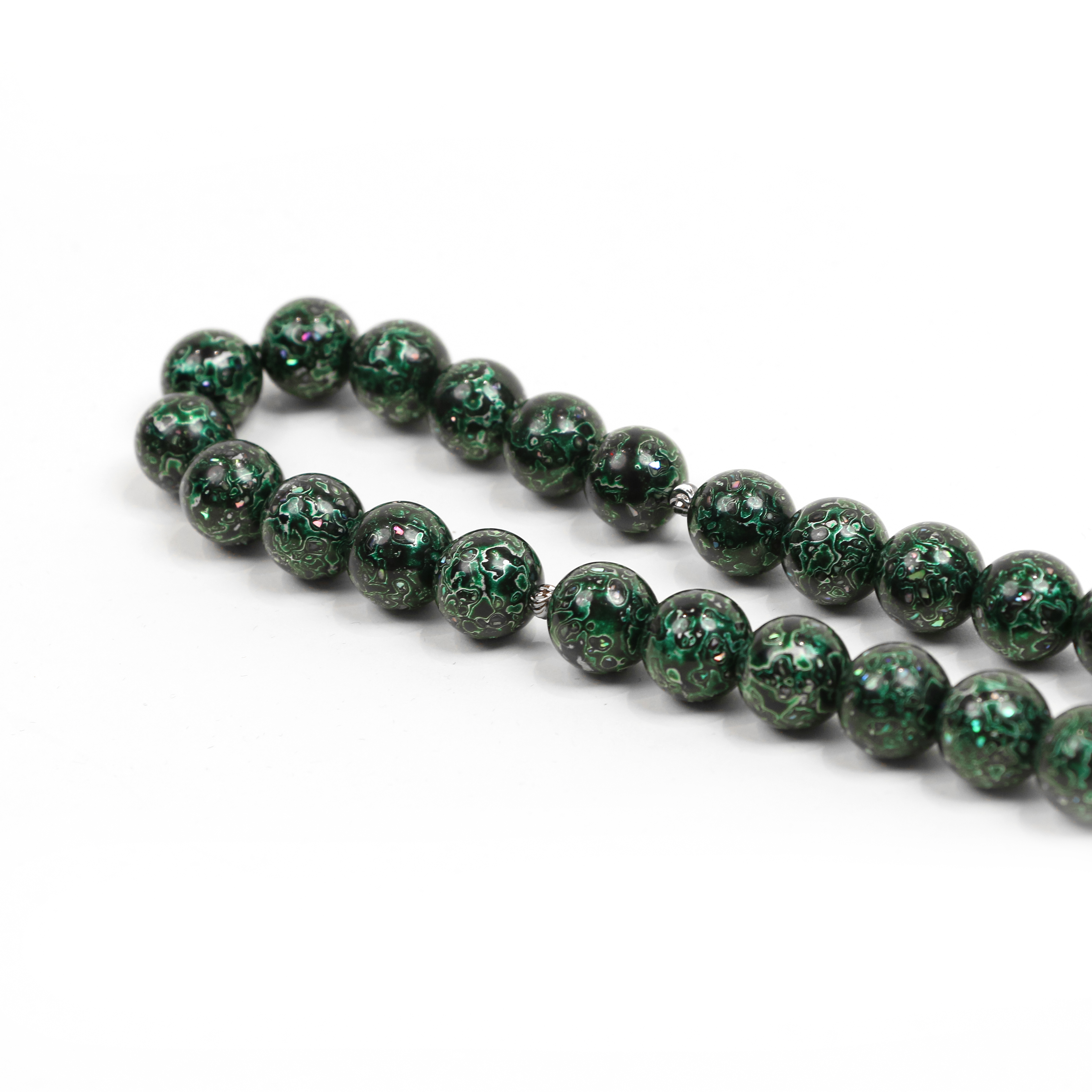 Green marbled bead necklace on a white background