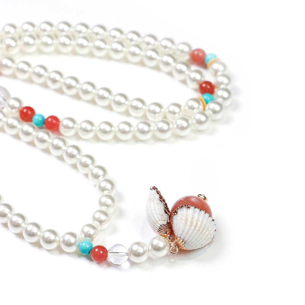Close-up of 99 bead meditation cycle with pearl and clear quartz beads