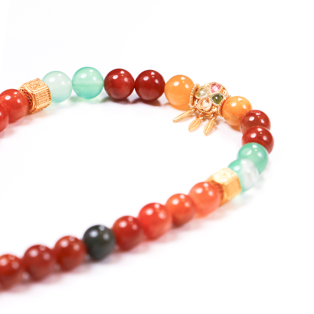 Close-up of Balance Clarity bracelet showing golden red black rutile needles