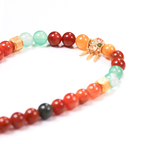 Close-up of Balance Clarity bracelet showing golden red black rutile needles