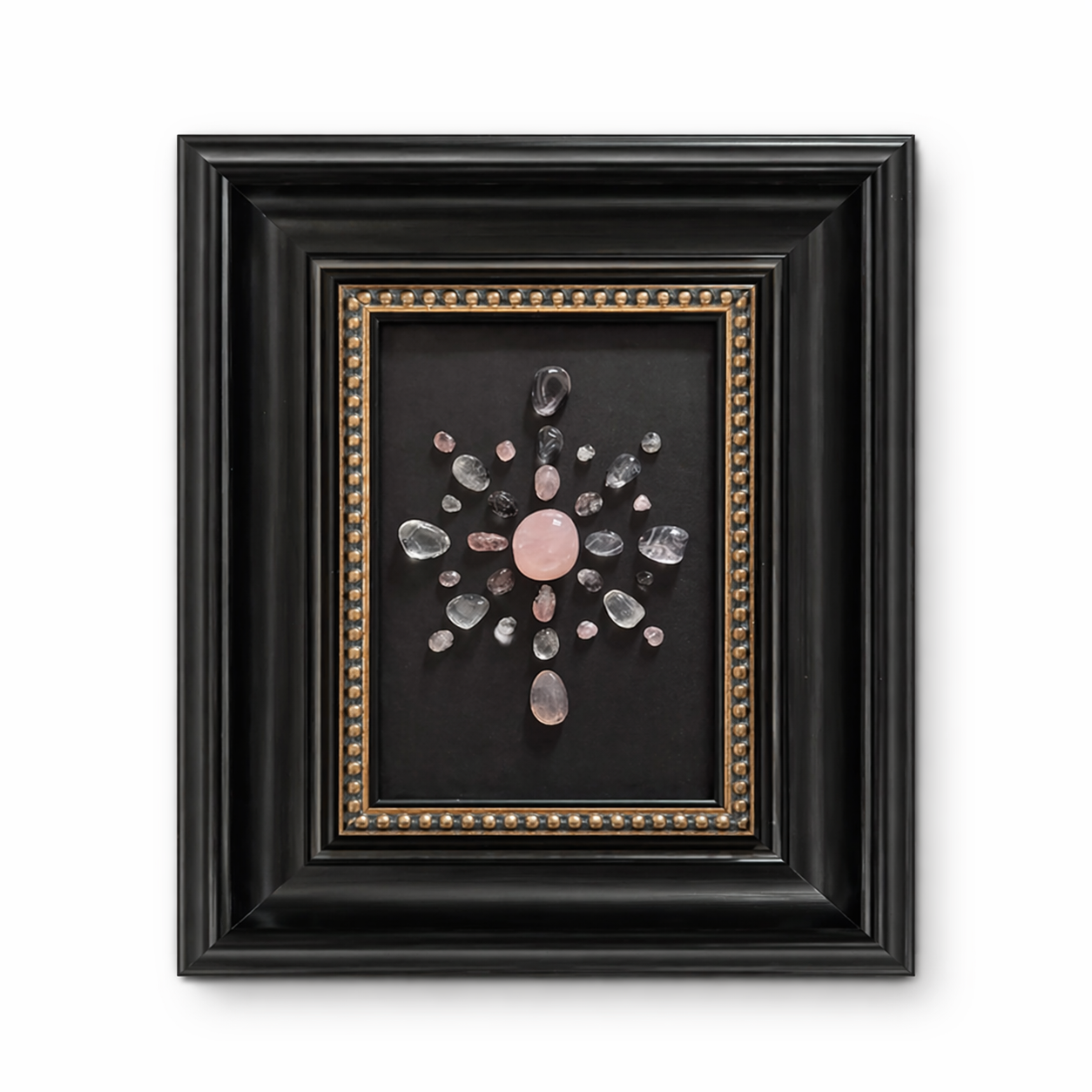 Rose quartz crystal star frame with soft pink beads on black background