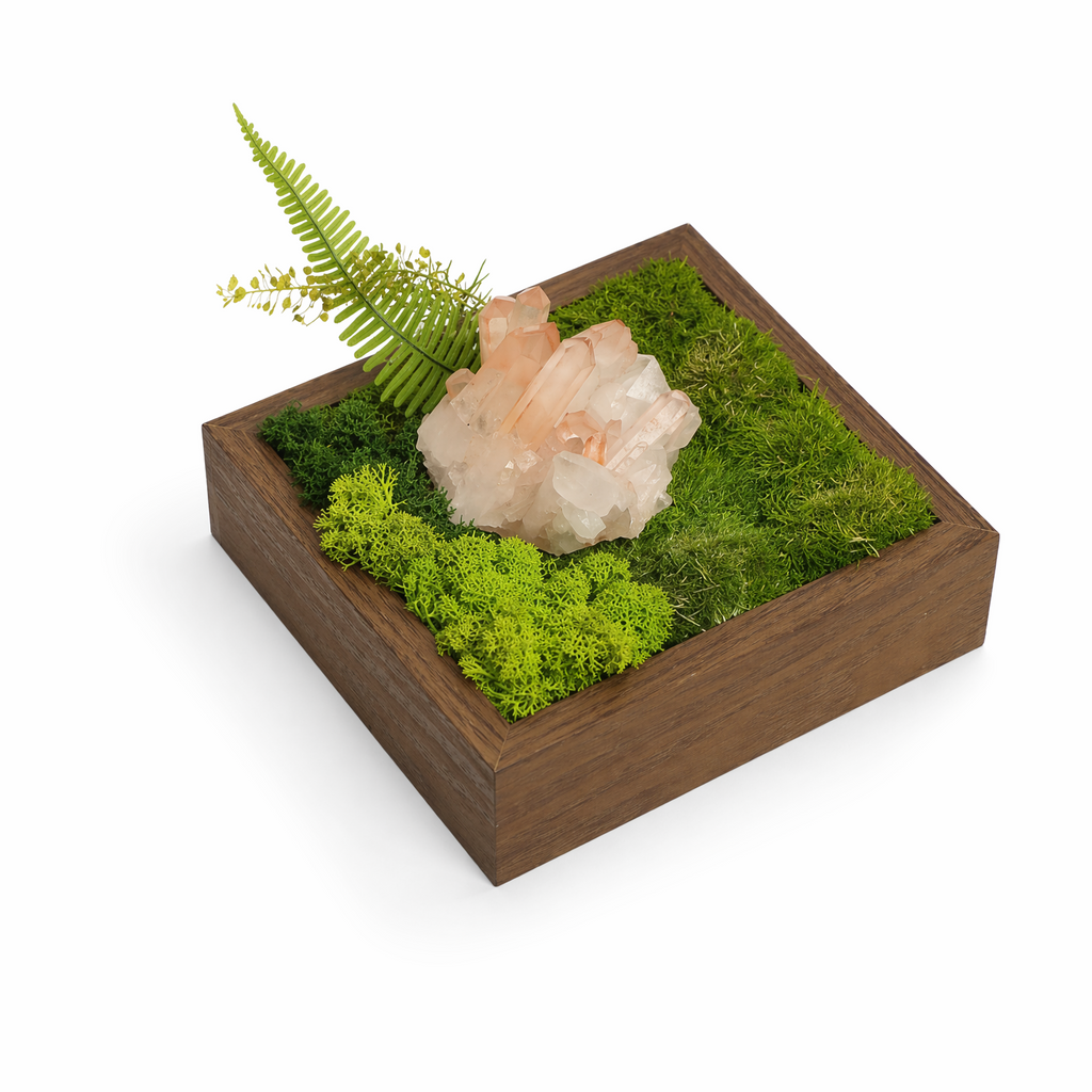 Close-up of crystal landscape tray showing pink white crystals and moss on wood