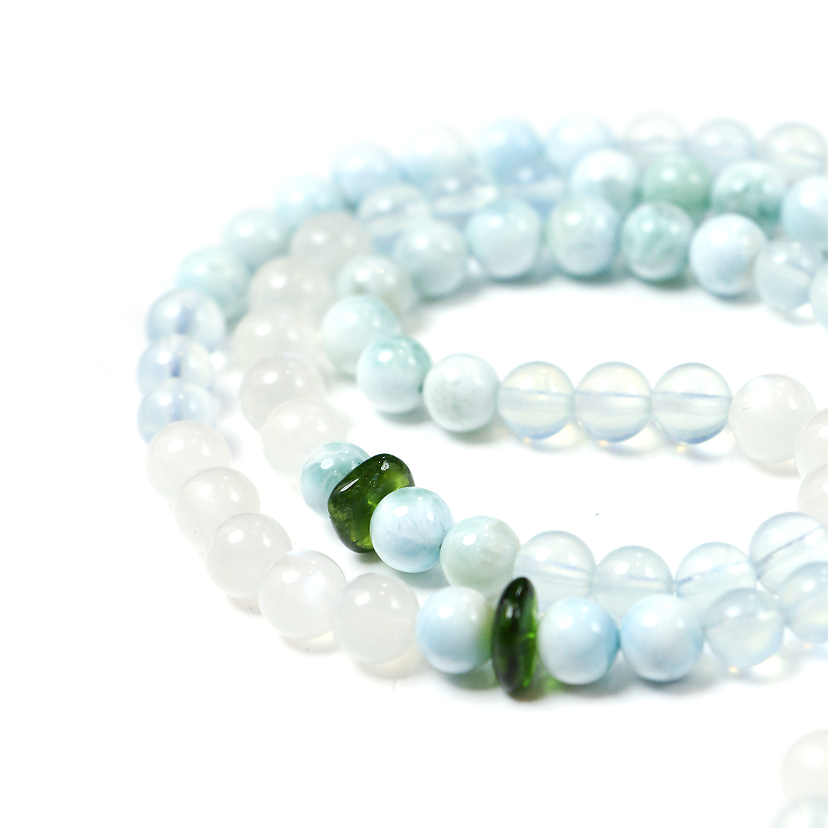 Close-up of 99 smooth crystal beads on Ease + Release meditation bracelet.