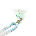 Close-up of 99 smooth crystal beads with fine crystal tassel detail
