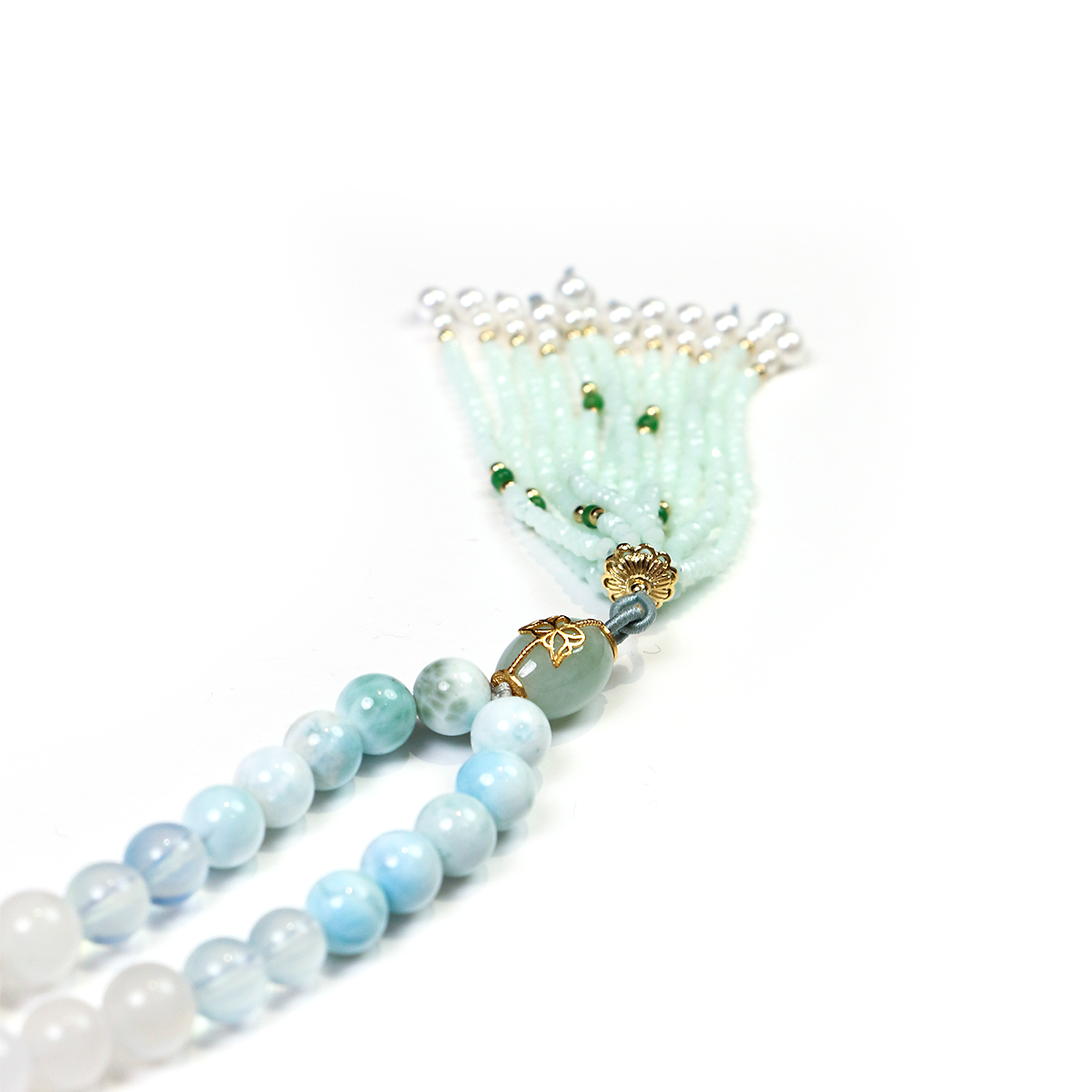 Close-up of 99 smooth crystal beads with fine crystal tassel detail