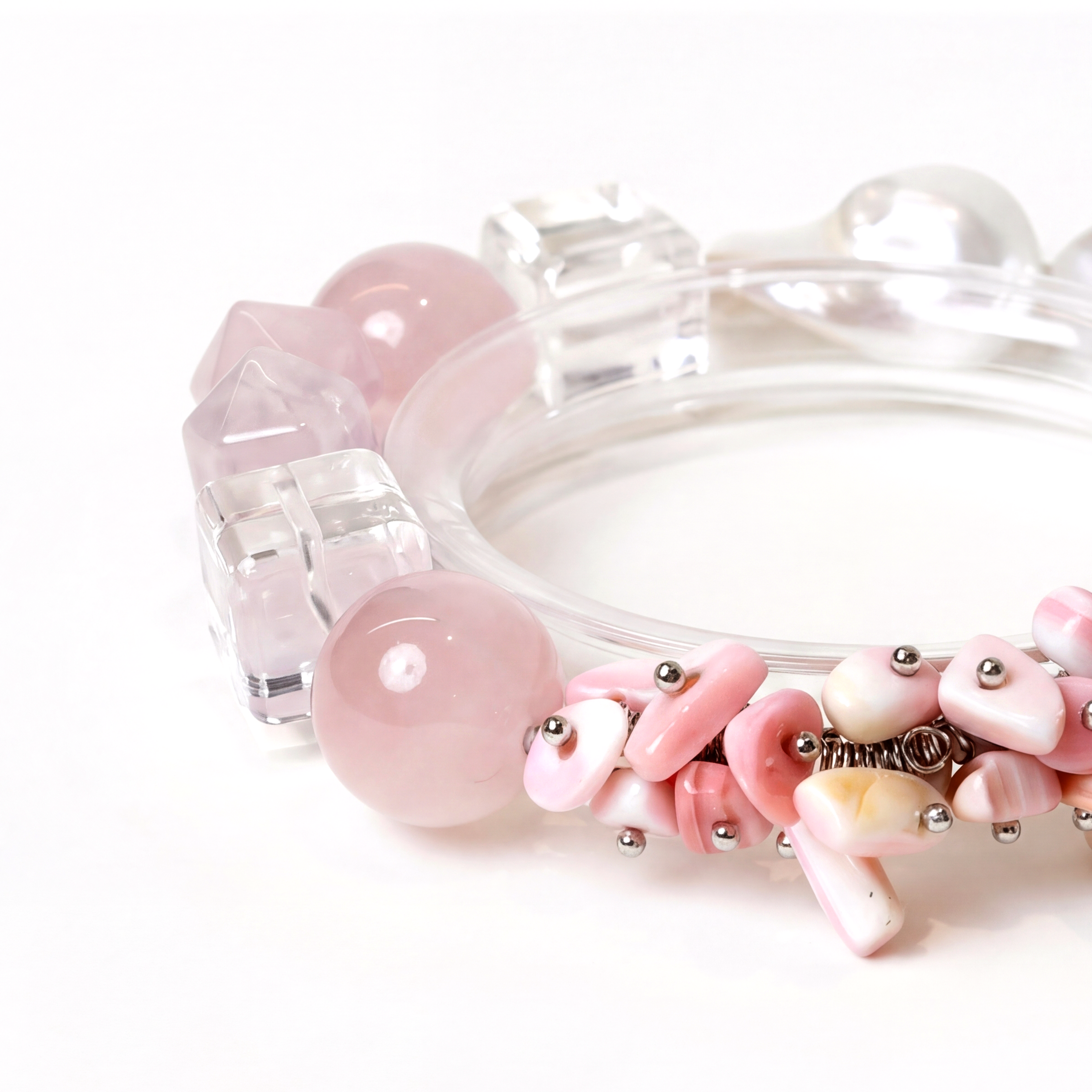 Close-up of a bracelet with pink and clear beads on a white background