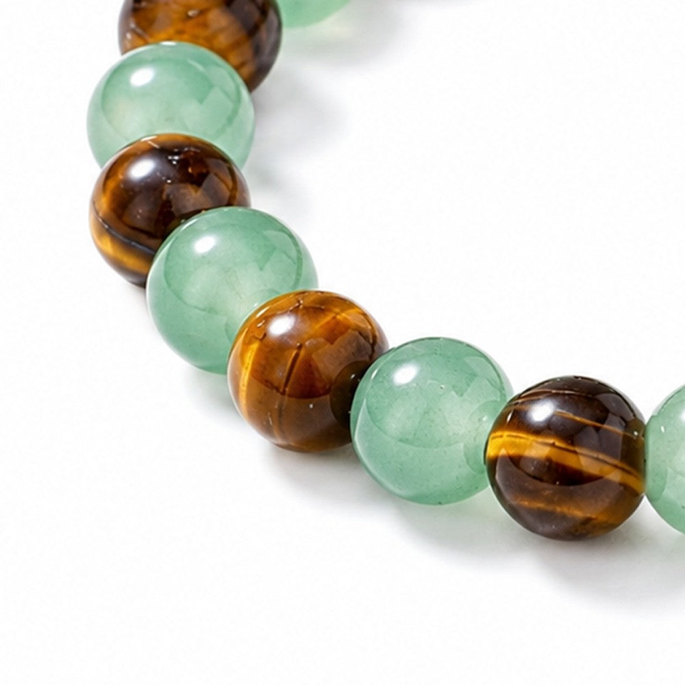 Bracelet with green beads and brown tiger eye stones on a white background