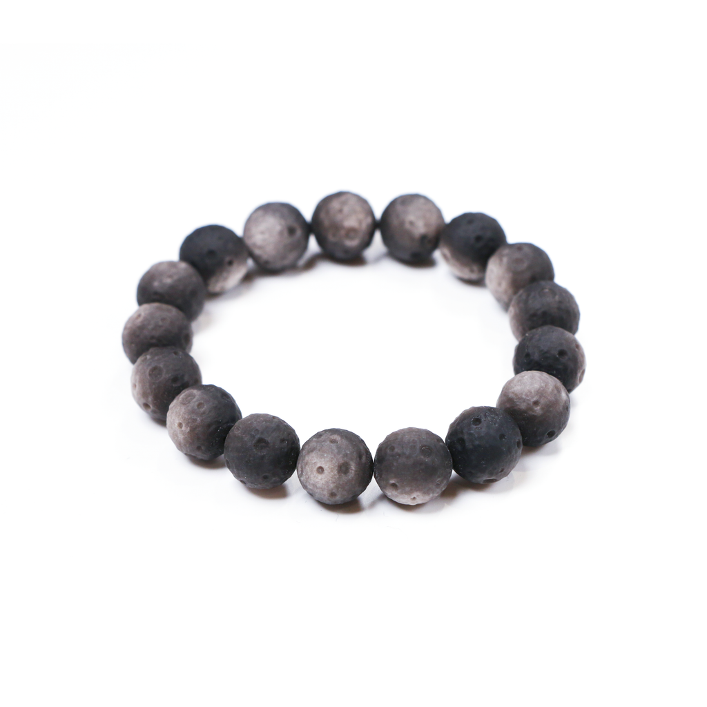 Close-up of reflective silver obsidian beads shaped like crescent moons