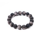 Close-up of reflective silver obsidian beads shaped like crescent moons