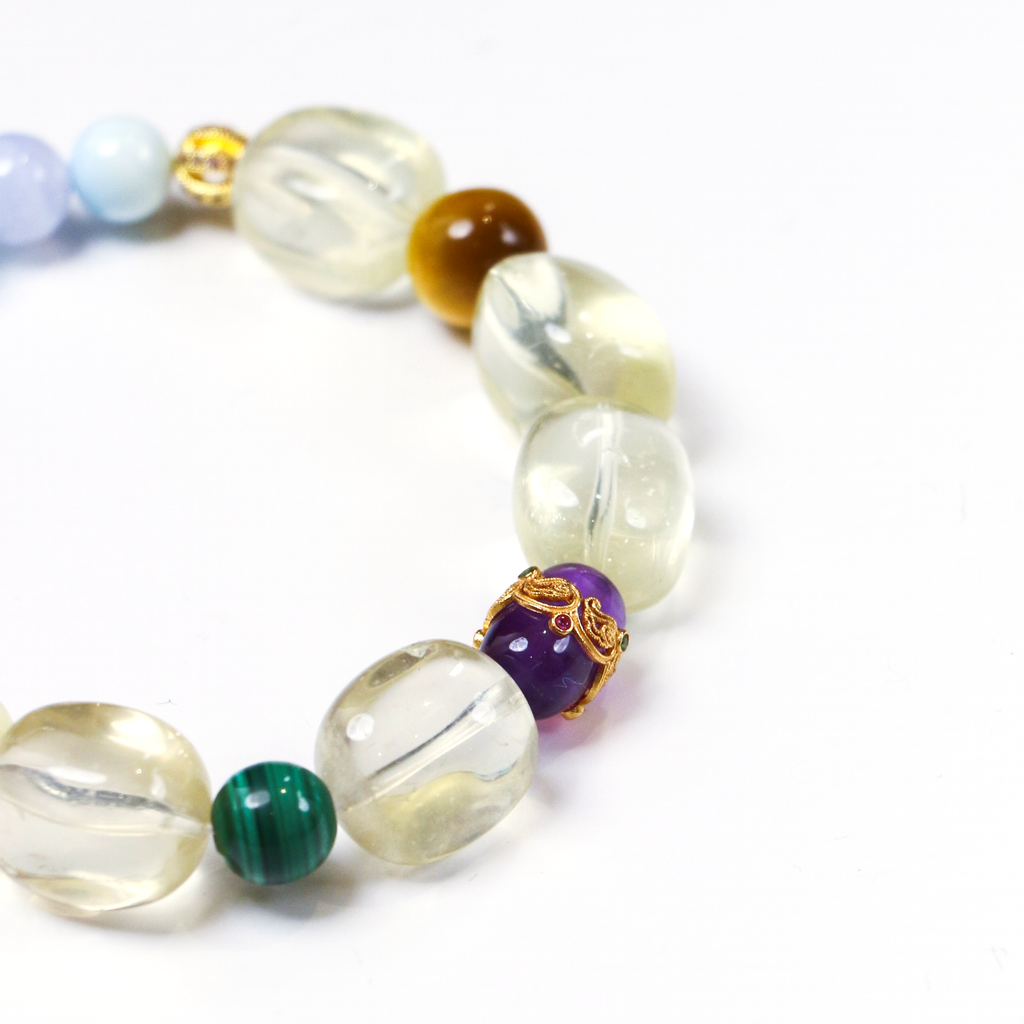 Detail of purple malachite and lapis lazuli beads on parrot crystal bracelet