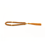 Close-up of golden blackwood cylinder beads with fine cord tassel