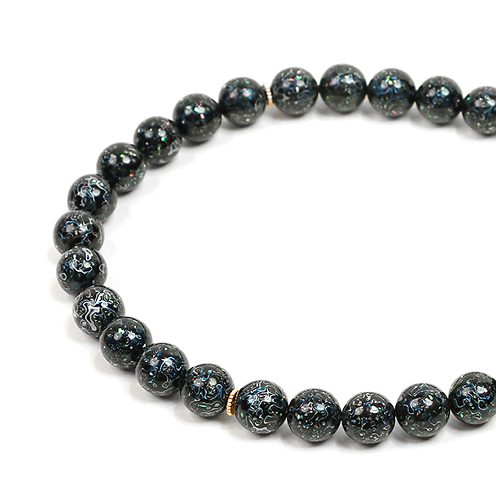 Black beaded meditation bracelet on a white background