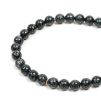 Black beaded meditation bracelet on a white background