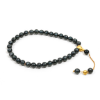Practice Mastery bracelet with blue blackwood beads and gold accents on white