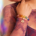 Close-up of a colorful beaded bracelet on a person's wrist with a blurred background