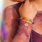 Close-up of a colorful beaded bracelet on a person's wrist with a blurred background