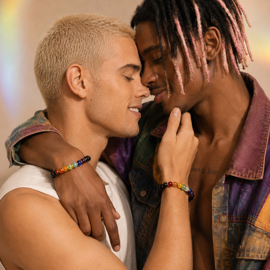 Two men embracing with a rainbow bracelet on one's wrist, set against a warm-toned background.