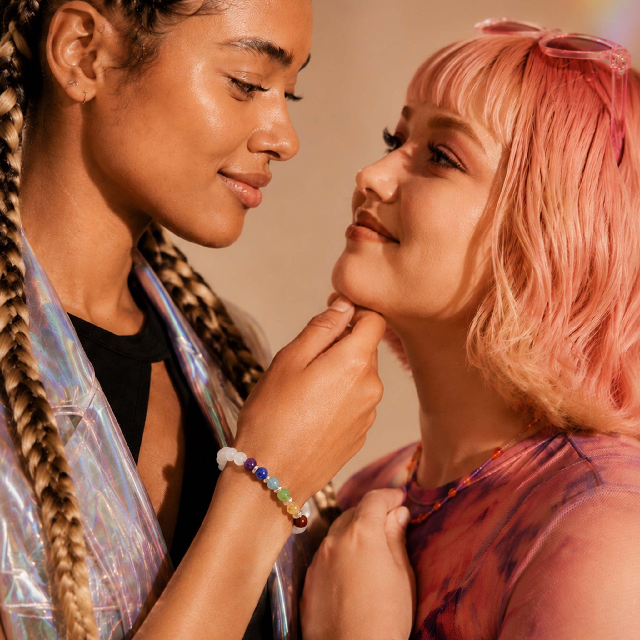Two women interacting closely with a warm, soft focus background