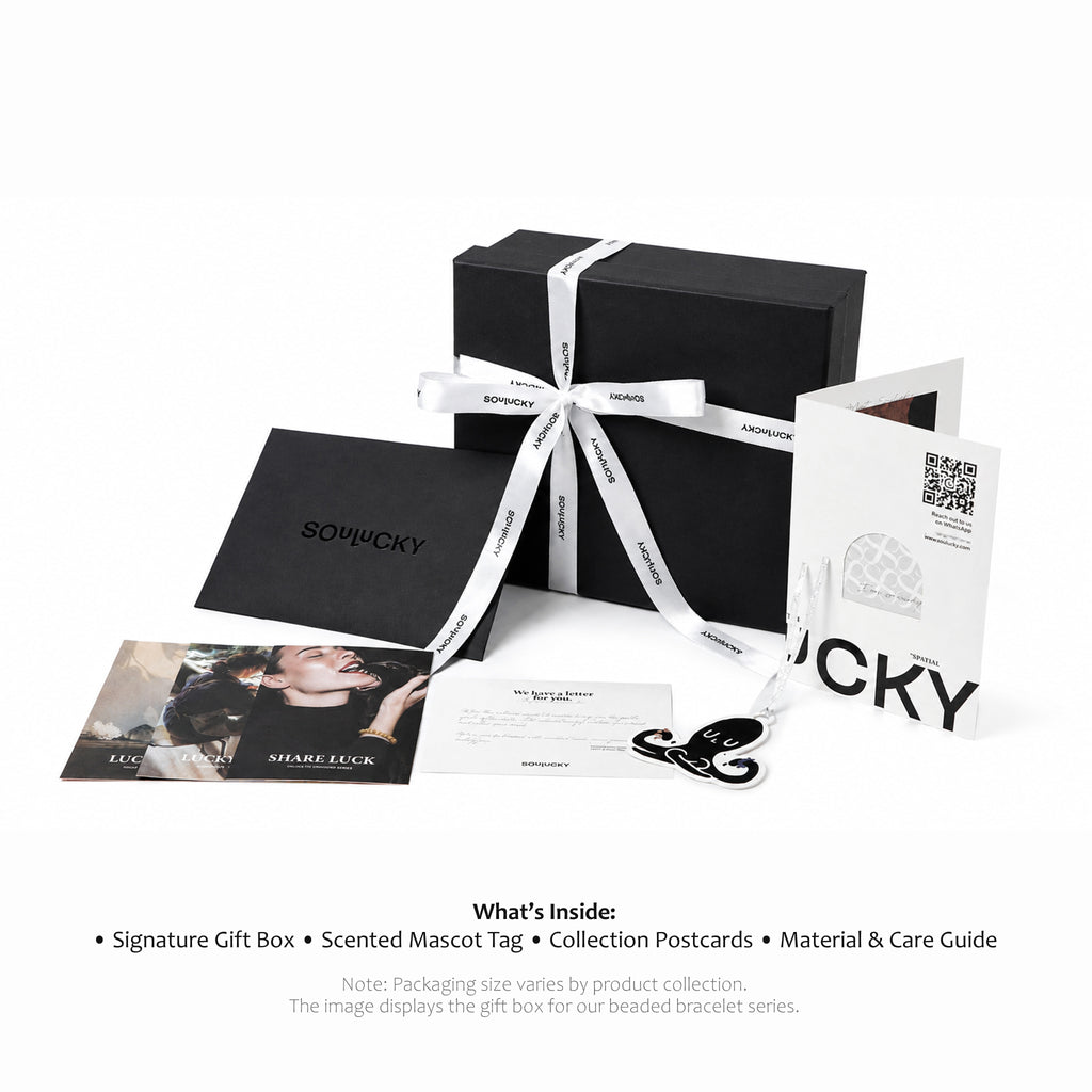Soulucky gift box set with black box, card, and postcard on a white background