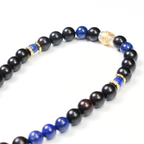 Close-up of Reason Clarity bracelet showing deep blue lapis lazuli cylinder beads