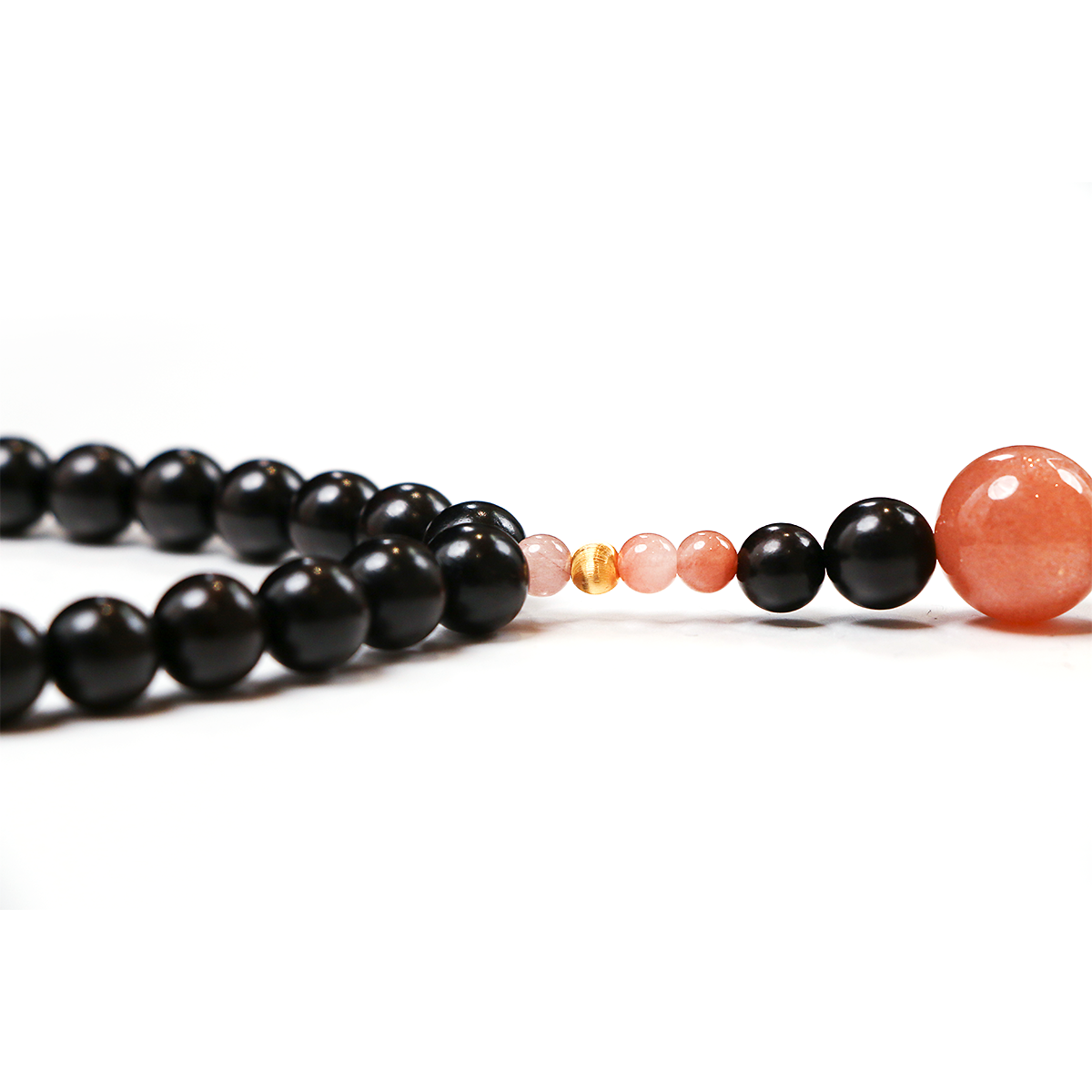 Release + Recovery meditation bracelet with sunstone ebony tassel detail