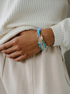 Close-up of handcrafted water bracelet with blue turquoise and clear crystal beads