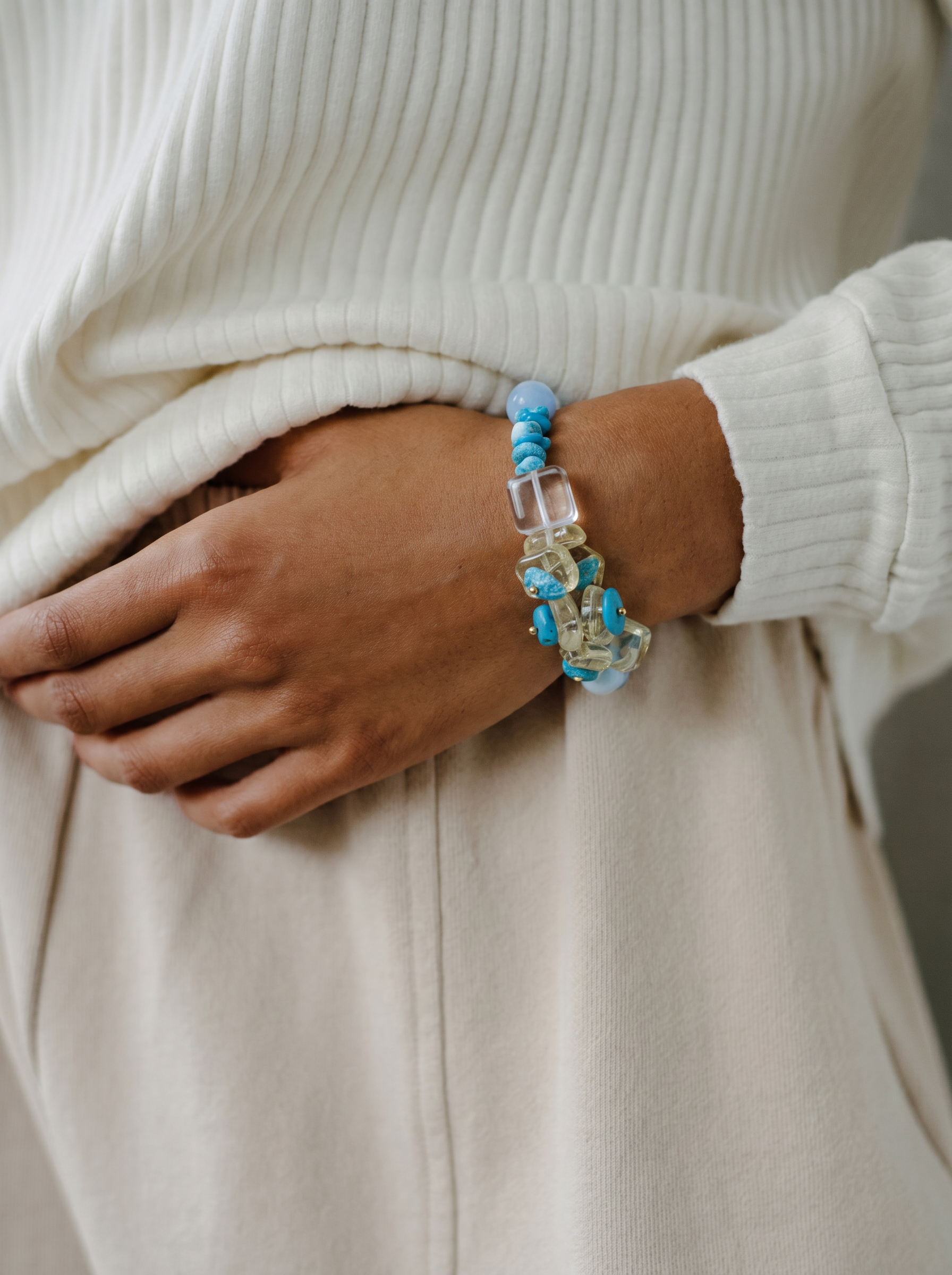 Close-up of handcrafted water bracelet with blue turquoise and clear crystal beads