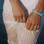 Water | Ease bracelet on model arm in coastal high-fashion setting